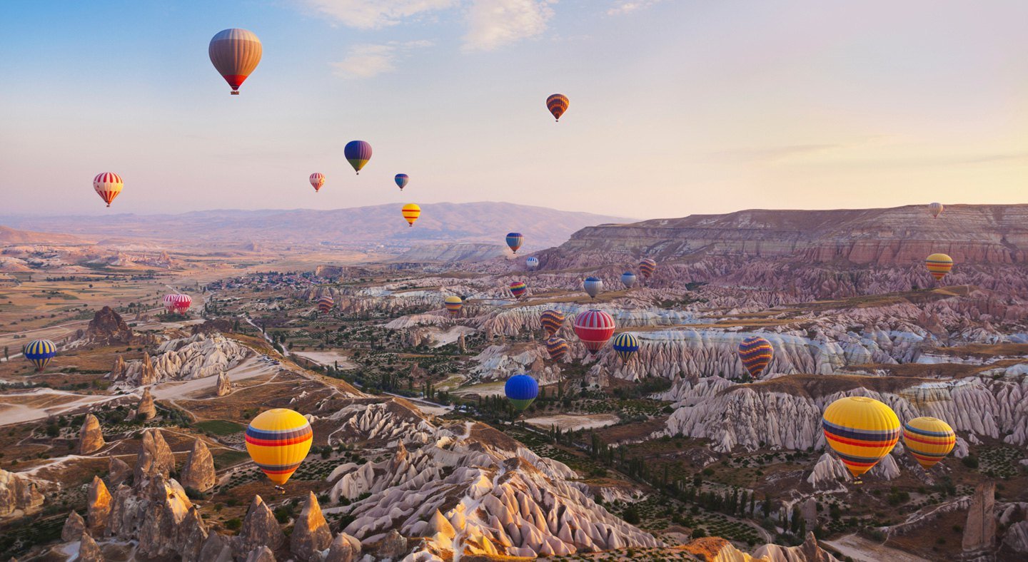 Hot air balloons over canyon