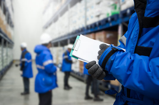 warehouse workers in blue jackets