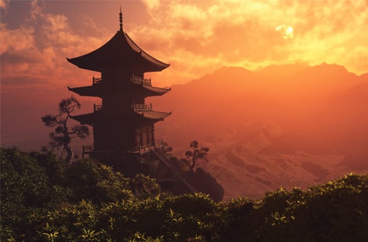 Pagoda on a mountaintop with an orange-colored sky in the background